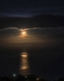 Moon over calm Caribbean sea, seen from Dominica, Eastern Caribbean. Sept. 2019