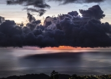 Dramatic sunset with storm clouds over Roseau). Caribbean sea view in Dominica, Lesser Antiles. Sept. 2019.