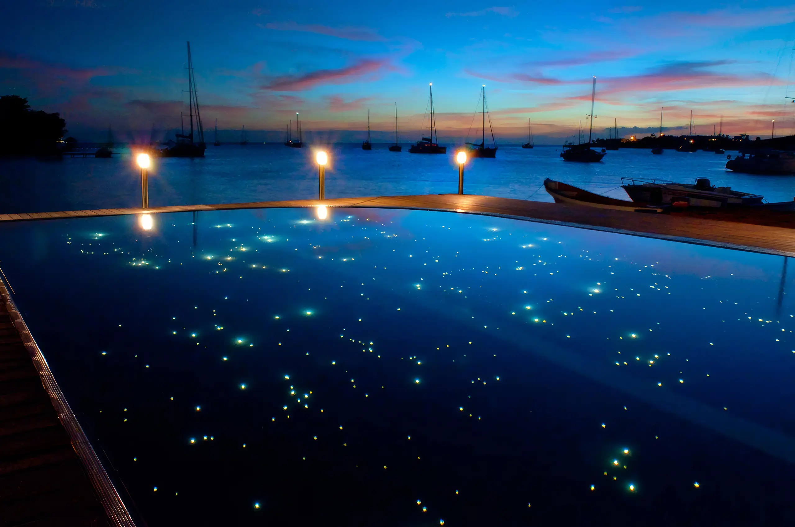 Prickly Bay, LED lit outdoor pool at night. Grenada, West Indies.